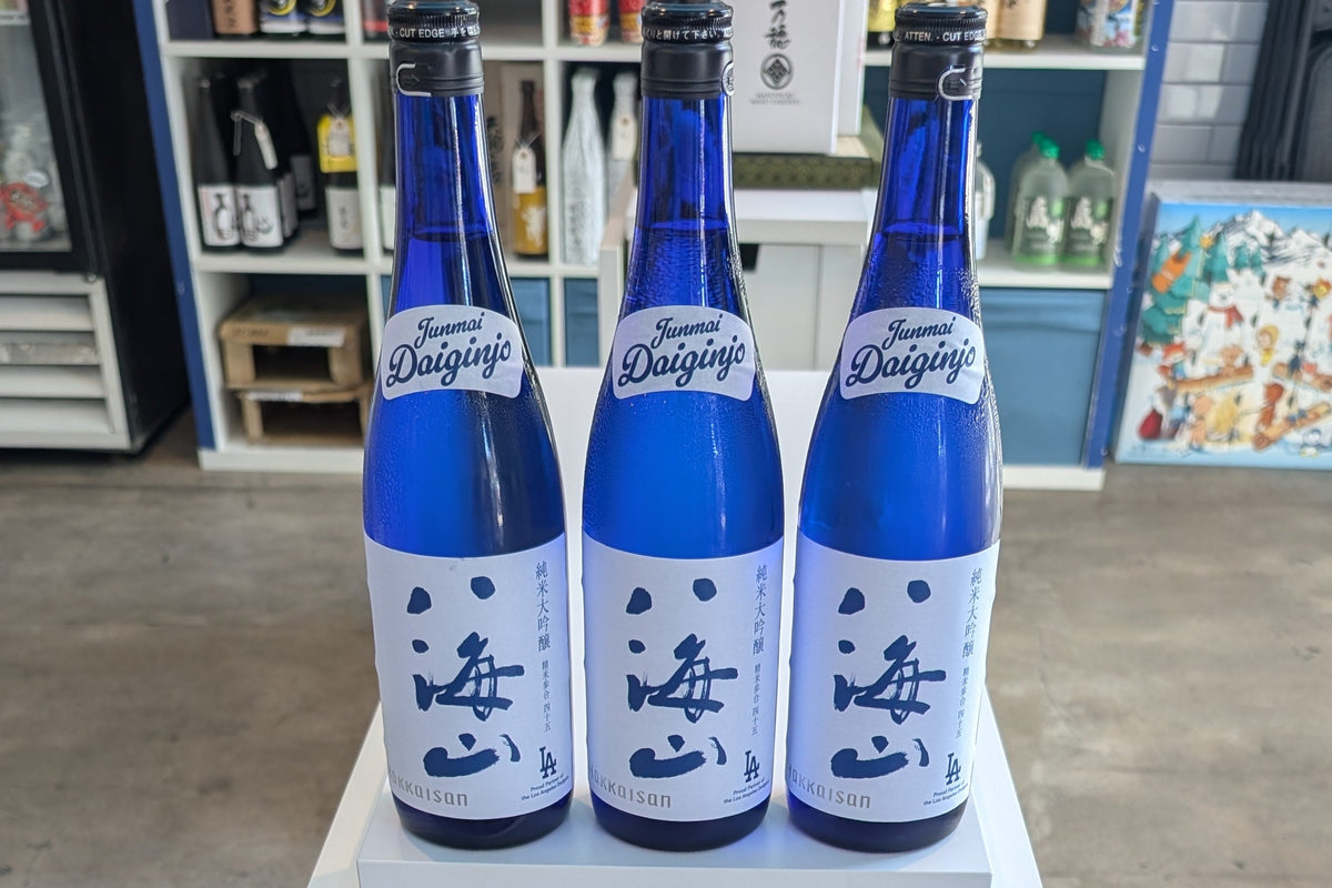 Dodger Blue Bottles of Sake with "Junmai Daiginjo" written in Dodger's unique font